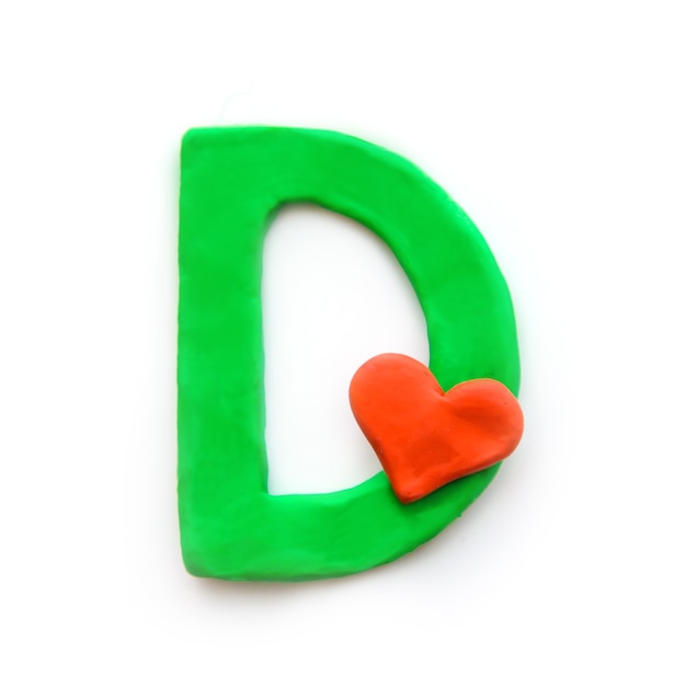 Green plasticine letter D English alphabet with red heart meaning love