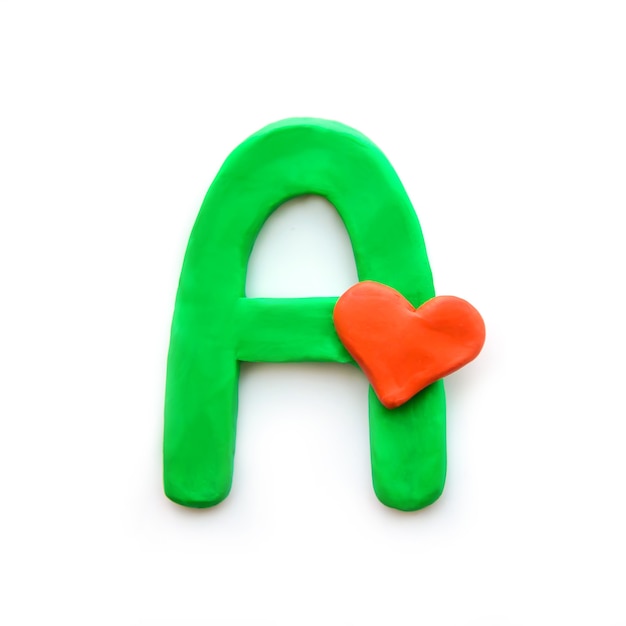 Green plasticine letter A English alphabet with red heart meaning love