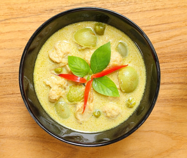 Green pork Curry in bowl ceramicThai cuisine on wood