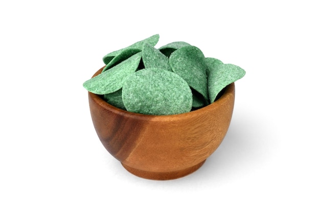 Green potato chips with green onion in wooden bowl isolated on white background.