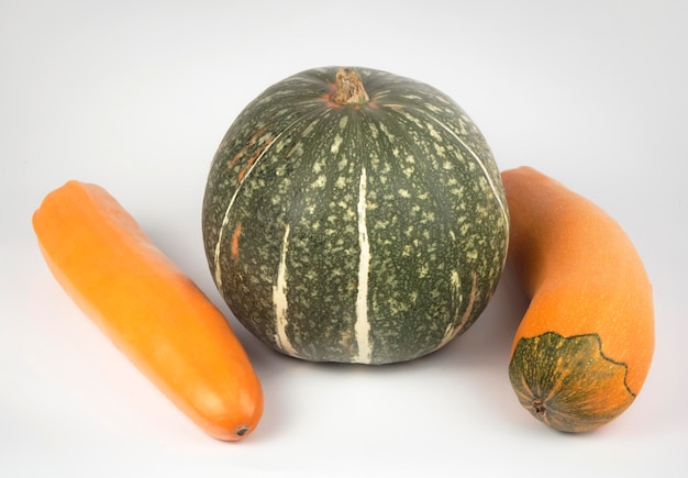 Green pumpkin and yellow zucchini on a white background