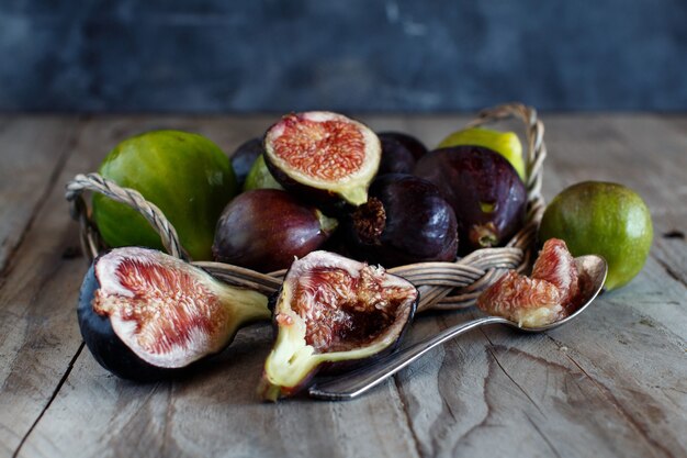 Green and purple figs on wooden