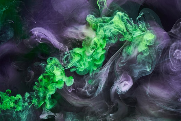 Green purple smoke abstract background acrylic paint underwater explosion