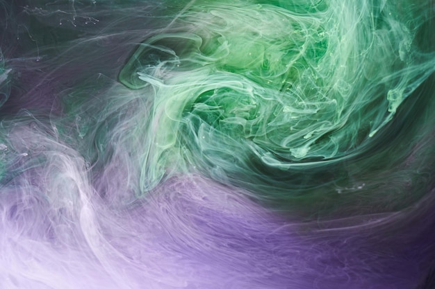 Green purple smoke abstract background acrylic paint underwater explosion