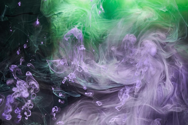 Green purple smoke abstract background acrylic paint underwater explosion