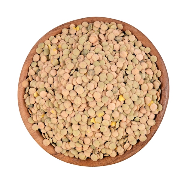 Green raw lentil in a wooden bowl on a white background