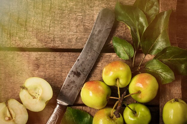 Green and red apples on rustic  table. toned photo