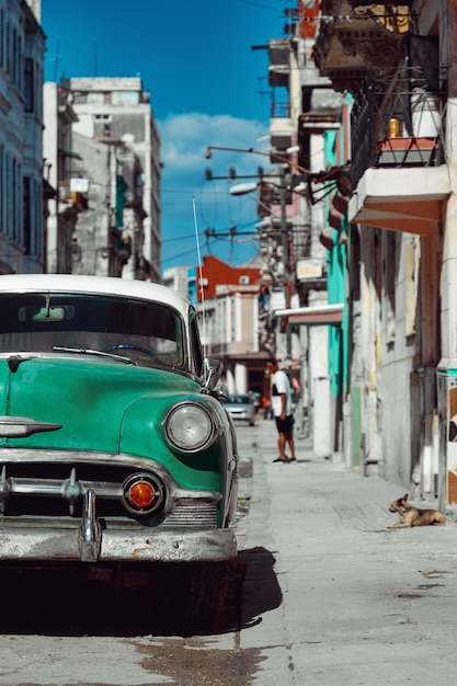 Green retro car parked on the street of Havana Cuba