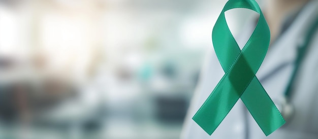 Green ribbon symbol for world bipolar day on blurred background