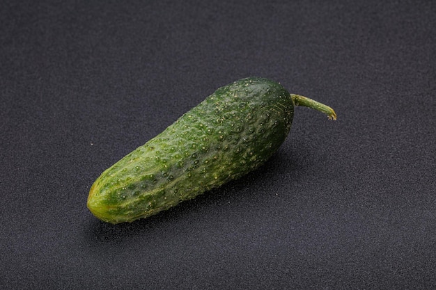 Green ripe fresh cucumber over background