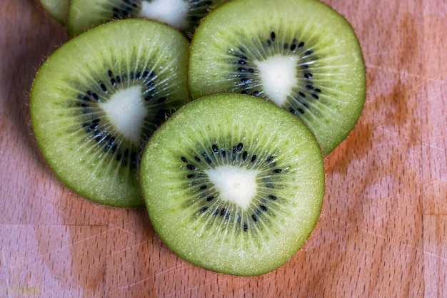 Green ripe kiwi cut into pieces during dessert preparation kiwi fruit cut into slices