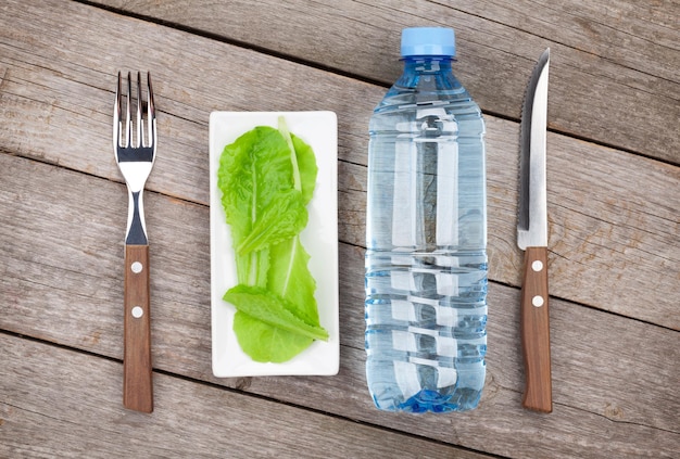 Green salad leaves and water bottle Healthy food