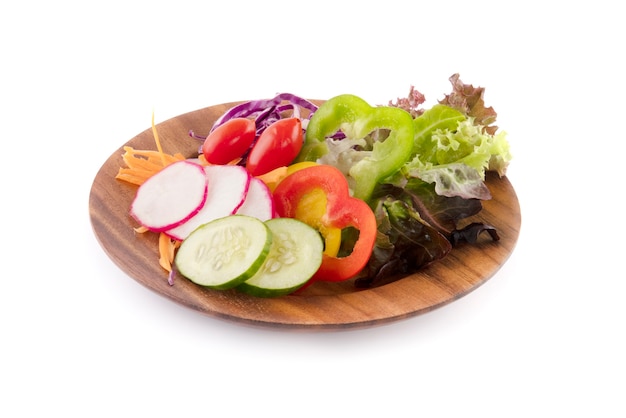 Green salad with tomato and fresh vegetables isolated on white surface