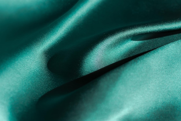 Green satin fabric pleats closeup Abstract trend background of the 2021 Tidewater Green color