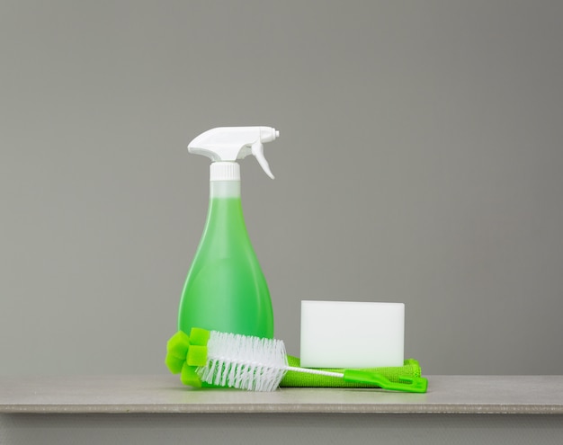 Green set of cleaning products and tools for spring cleaning.