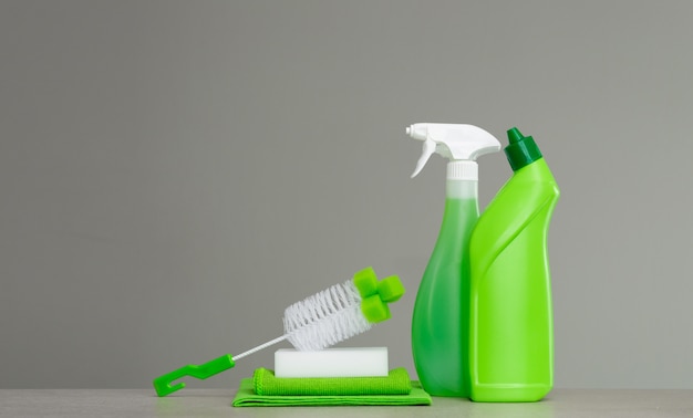 Green set of cleaning products and tools for spring cleaning.