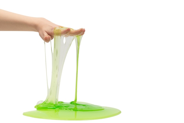 Green slime toy in woman hand isolated on white background.