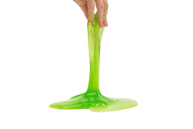 Green slime toy in woman hand isolated on white background.