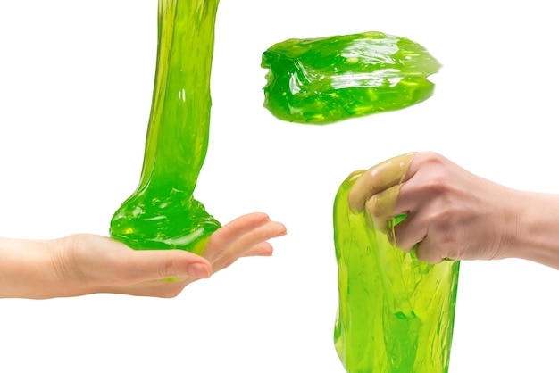 Green slime toy in woman hand isolated on white