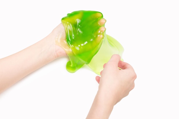 Green slime toy in woman hand isolated on white