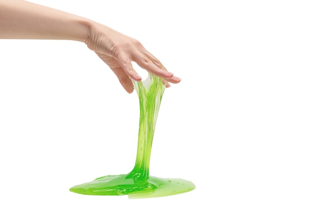 Green slime toy in woman hand isolated on white 