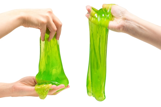 Green slime toy in woman hand isolated on white.