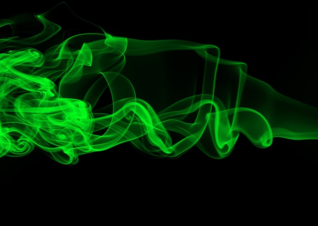 Green smoke abstract on black background darkness concept