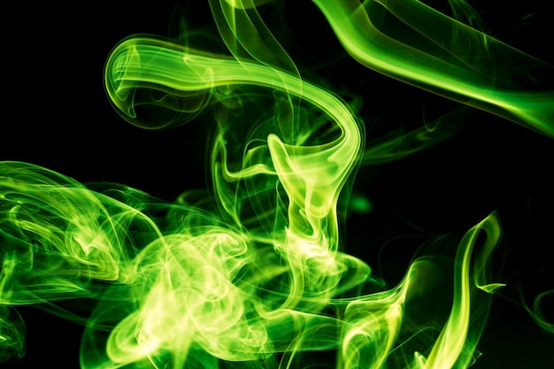 Green smoke on black background.