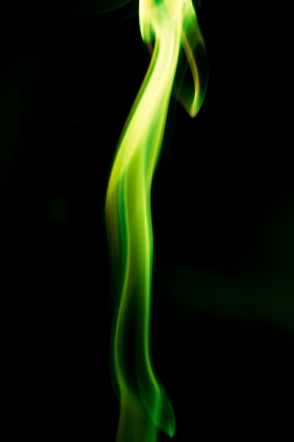 Green smoke on black background.