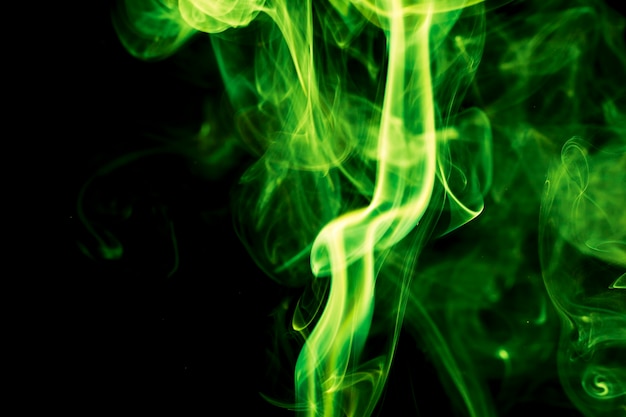 Green smoke on black background.