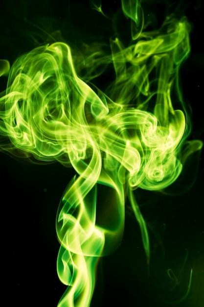 Green smoke on black background.