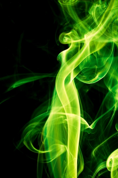 Green smoke on black background.