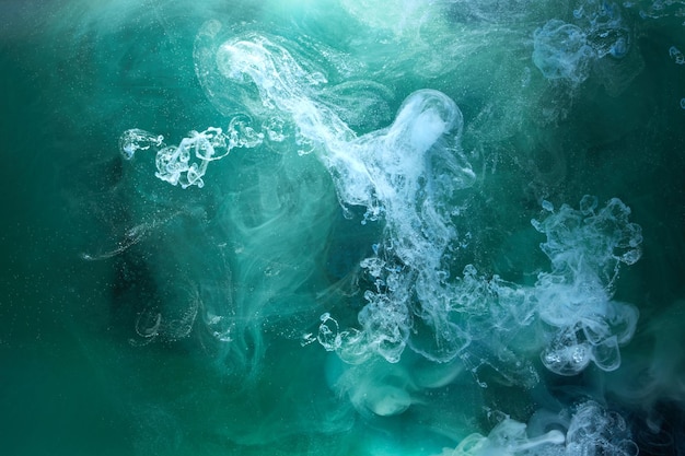 Green smoke on black ink background, colorful fog, abstract swirling emerald ocean sea, acrylic paint pigment underwater