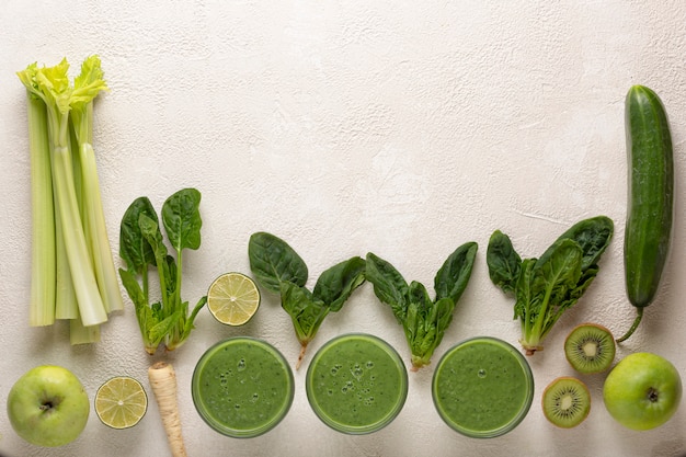 Green smoothie ingredients and glasses