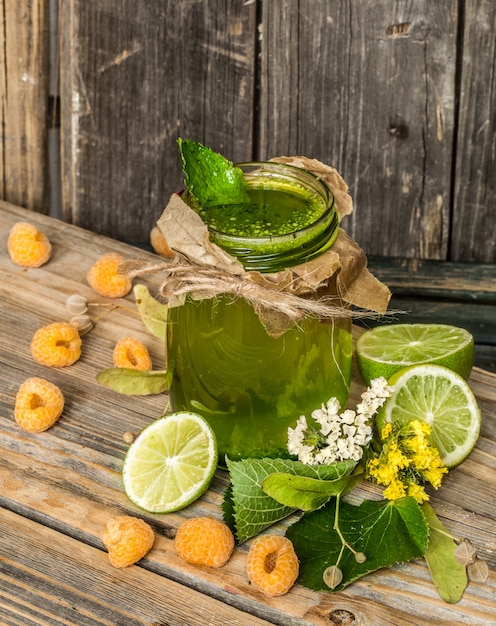 green smoothie in a jar with lime, kiwi and berry