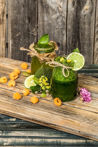 green smoothie in a jar with lime, kiwi and berry