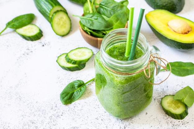 Green smoothie recipe Fresh smoothie with cucumber avocado and spinach Copy space