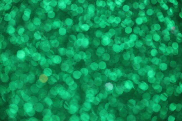 Green sparkle blurry background with fuzzy dots texture