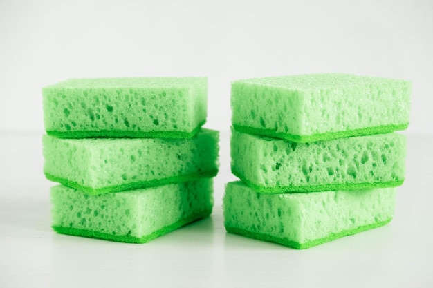 Green sponges for cleaning on a white background