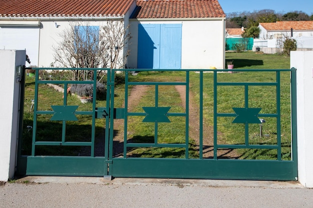 Green steel classic old vintage portal style metal driveway entrance gate access entry home