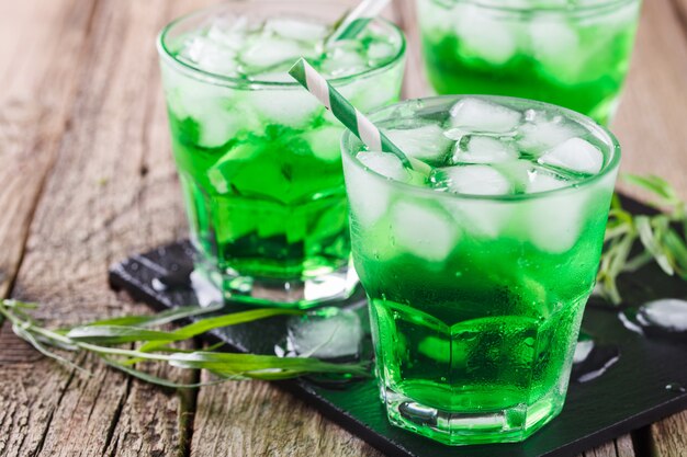 Green tarragon drink with  ice cubes,