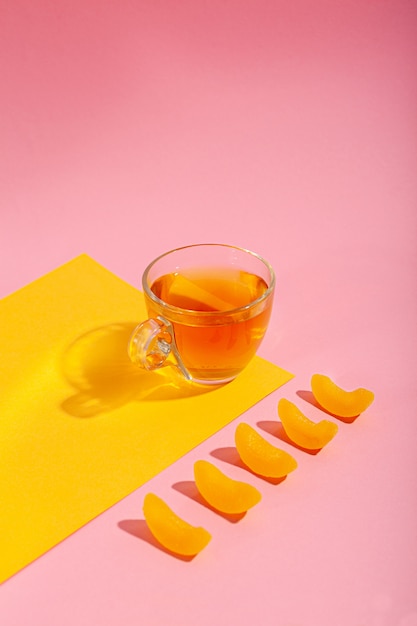 Green tea in a cup on a pink background