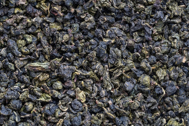 Green tea leaves background Oolong tea Abstract food textures Close up top view The high end tea of China