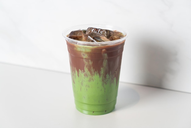 Green tea matcha latte with chocolate in glass