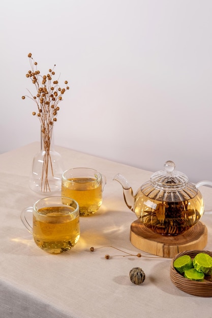 Green tea oolong in glass teapot on table Hot tea is in the glass cups