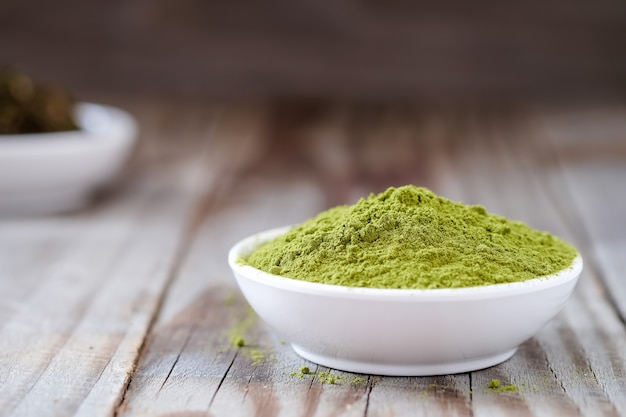 Green tea powder with dried tea in white cup