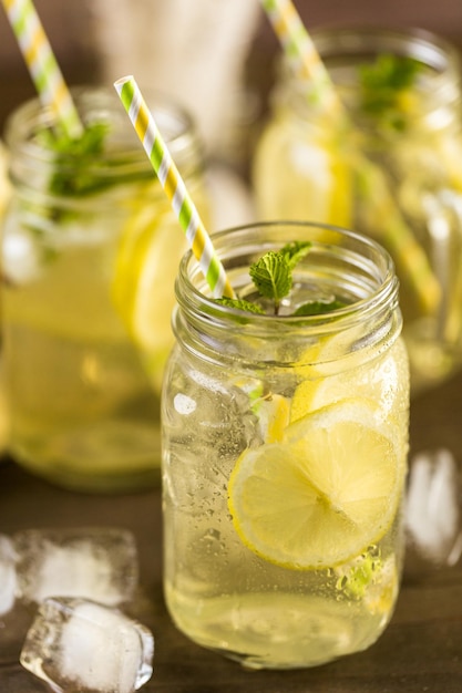 Green tea with citrus in drinking mason jar with ice.