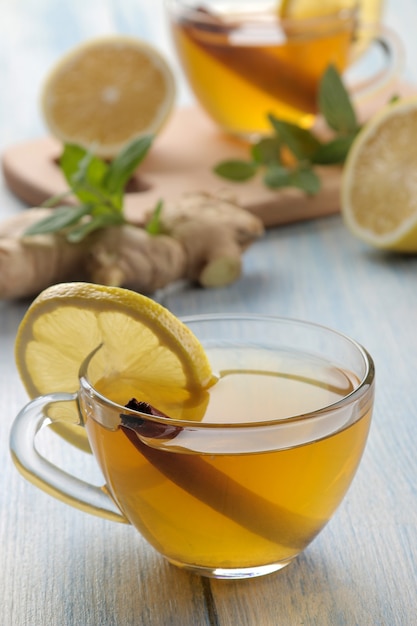 Green tea with lemon and cinnamon in a glass cup