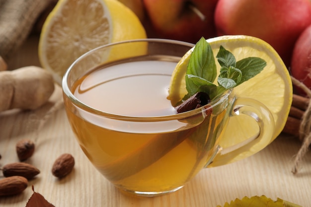 Green tea with lemon and cinnamon in a glass cup