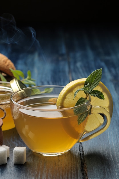 Green tea with lemon and cinnamon in a glass cup